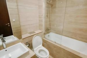 a bathroom with a toilet and a sink and a tub at Sellaracz Residance 014 in Tegaldanas