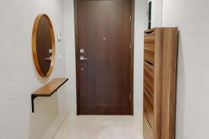 a bathroom with a wooden door and a mirror at Sellaracz Residance 014 in Tegaldanas +5 photos