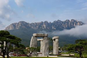 a large stone monument with a mountain in the background at Sokcho Seorak Port Healing House 4 Rooms, 2 Beds Seorak Mt View in Naemulch'i-ri