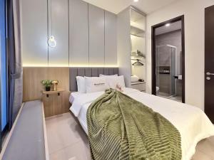 a bedroom with a large bed in a room at LuMen By SanLiving - 3BR - NICE Expo - Free Parking in Rawalumpang