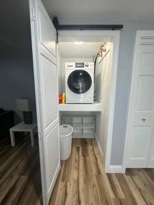 a kitchen with a washer and dryer in a room at Escape and relax ,Walk to the Beach in East Greenwich