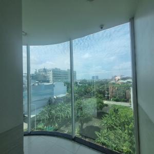 a view of a city from a window in a building at KHÁCH SẠN MlLAN in Dĩ An