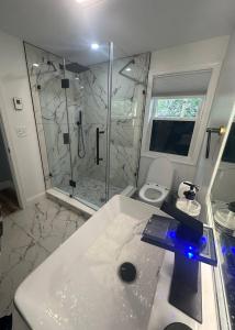 a bathroom with a shower and a toilet and a sink at Escape and relax ,Walk to the Beach in East Greenwich +24 photos