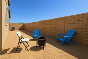 two blue chairs and a trash can on a patio at #Marbella Lane - Spacious 4BR Modern Family Home! in Placentia