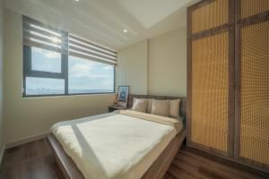 a bedroom with a large bed and a window at Tobe in Hue 1 - Cozy Apartment with Pool and Gym & City View in Thôn Văn Dương +54 photos