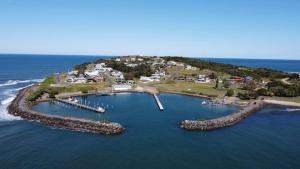 an aerial view of an island in the ocean at Little Street Retreat - Harrington in Harrington