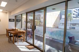 an office with a wooden table and glass walls at BeHome Boulevard in Gold Coast