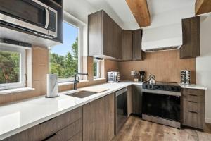 a kitchen with wooden cabinets and a window at The Adelynn 5BR - Sleek - Spacious - Walkable in Portland
