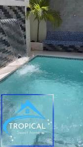 a swimming pool with a water fountain at Tropical sweet home in Los Frailes