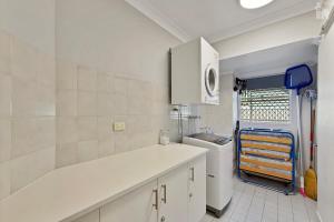 a kitchen with a sink and a white counter top at Villa Venezia Apt 3 - Spacious Hervey Bay esplanade apartment in Hervey Bay +17 photos