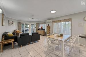 a living room with a couch and a table at Villa Venezia Apt 3 - Spacious Hervey Bay esplanade apartment in Hervey Bay