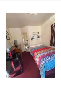 una camera da letto con un letto con una coperta colorata di KoBala Lee High Inn a Fairfax