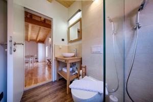 a bathroom with a shower and a toilet and a sink at Apartments Villa Glorija in Komiža +34 photos