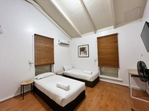 a room with two beds and a tv and two windows at big group house Westbourne park 