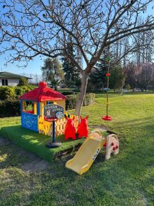 a playground with a slide and a play house at EcoHotel El Almendro in Paine