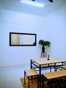 a room with tables and a mirror on the wall at Myrol Homestay Padang Serai Kulim in Padang Serai