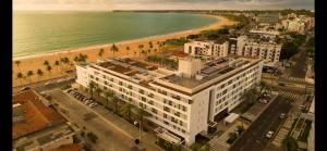 an aerial view of a building next to a beach at Loft Alto padrão na beira mar de Tambaú in João Pessoa