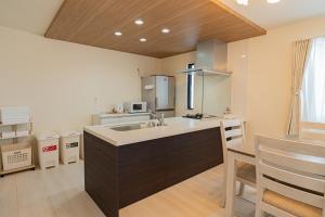 a kitchen with a sink and a counter at Tropical Beach Vacation House in Ginowan