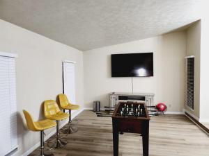 a living room with a chess board and yellow chairs at Complete Home with everything in The Colony