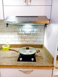 a frying pan on a stove in a kitchen at 2114T2 Avida Towers Cebu IT Park 2BR Unit 2 Toilet 2 TV in Cebu City