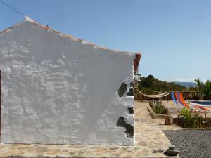a white wall next to a swimming pool at Casa Domi in La Esperanza +13 photos