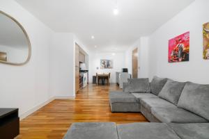 a living room with a couch and a table at Modern 1BR Apartment near Edgbaston Cricket Ground in Birmingham