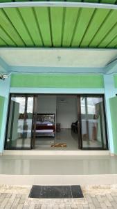 a room with a large glass window in a house at Awak Awai in Pulau Rubia +1 photo