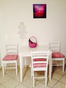 a white table with two chairs and a basket on it at Bellus Apartment-COMPLETELY RENOVATED in Split