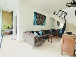 a living room with a couch and a staircase at OASIS 66 Villa - Heart of Legian/Seminyak - Double Six in Seminyak