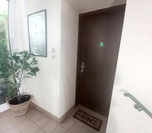 a black door in a room with a plant at Les remparts in Ensisheim