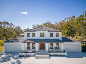 a large white house with a garage at La La Land by Coast Hosting in Tascott