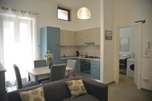 a living room and kitchen with a couch and a table at TOI Apartments in Brindisi