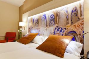 um quarto de hotel com uma cama e uma parede em Porcel Sabica em Granada
