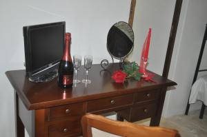 a wooden desk with a bottle of champagne and glasses at Masseria Costanza in Putignano