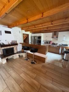a kitchen with a counter and stools in a room at Beskid House Kurów in Kurów