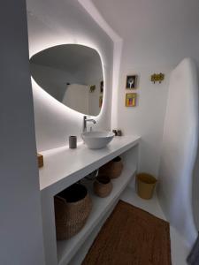 a bathroom with a sink and a mirror at Tzia Blue in Koundouros +15 photos