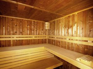 a wooden sauna with a bench in the middle at Luxurious Mansion in Saint Preuil with Sauna in Saint-Preuil