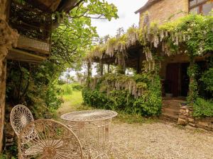 a table and chairs in the yard of a building at Dreamy Holiday Home in Clermont in Saint-Médard-dʼExcideuil