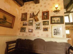 a room with a wall with pictures on the wall at Dreamy Holiday Home in Clermont in Saint-Médard-dʼExcideuil