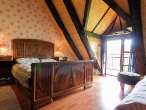 a bedroom with a wooden bed in a attic at Dreamy Holiday Home in Clermont d Excideuil with Fireplace in Saint-Médard-dʼExcideuil