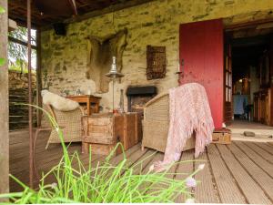 a room with two chairs and a table and a red door at Dreamy Holiday Home in Clermont d Excideuil with Fireplace in Saint-Médard-dʼExcideuil