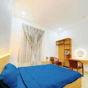 a bedroom with a blue bed and a window at Mie's Homestay in Da Nang +23 photos
