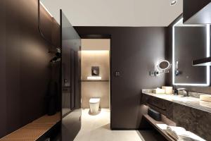 a bathroom with a sink and a toilet and a mirror at Atour Hotel Yintai Department Store at Wenzhou South Station in Wenzhou +35 photos