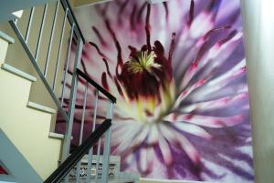 a staircase with a painting of a flower on the wall at Hotel Doña Luisa in San Luis de Sabinillas