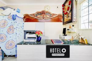 a hotel room with a desk and a bed at Super Hotel O Chittoor Railway Station Formerly Four Oaks in Chittoor