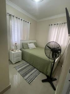a bedroom with a fan next to a bed at XV Apartamento en san Isidro in Mendoza +2 photos