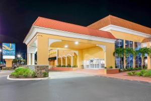 a shopping center with a building at night at Quality Inn & Suites Conference Center in New Port Richey