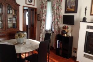 a living room with a table and chairs and a fireplace at Resort la villa in Cassine