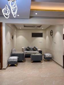 a waiting room with couches and tables in a building at #101 Gokula Srigandha Fragrance in Shimoga