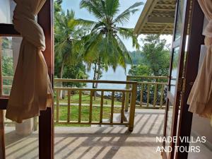 a view from the balcony of a house with a view of the water at Nade villas madu river wives in Balapitiya +2 photos